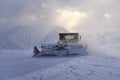 Snowcat rides to work in the evening Royalty Free Stock Photo