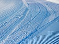 Snowcat tracks in the snow. The stripes form an amazing snowy texture