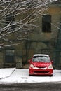 Snowclad Red Car Against Old House Royalty Free Stock Photo