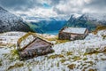 Snowcovered cabins with grass roof above norwegian fjord Royalty Free Stock Photo