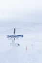 Snowcovered route sign and crossmarks