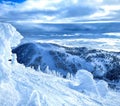 Snowdrifts are scattered around backcountry overlooking Vogel ski resort slopes.