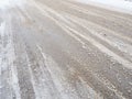 Snowdrifts on the side of the road. Bad weather and traffic. Snow on asphalt. Difficult driving conditions. Winter slosh Royalty Free Stock Photo