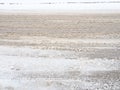 Snowdrifts on the side of the road. Bad weather and traffic. Snow on asphalt. Difficult driving conditions. Winter slosh Royalty Free Stock Photo