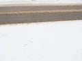 Snowdrifts on the side of the road. Bad weather and traffic. Snow on asphalt. Difficult driving conditions. Winter slosh Royalty Free Stock Photo