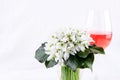 Snowdrop bouquet, white spring flowers and pink wine on light background. Copy space Royalty Free Stock Photo