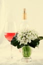 Snowdrop bouquet, white spring flowers and pink wine on light background. Copy space Royalty Free Stock Photo