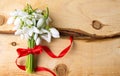 Snowdrops bouquet on natural wooden board Royalty Free Stock Photo
