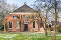 Snowdrops in front of a historic farm house in Groningen Royalty Free Stock Photo