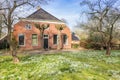 Snowdrops in front of a historic farm house in Groningen Royalty Free Stock Photo