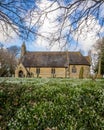 Snowdrops in front of a small English church. Royalty Free Stock Photo