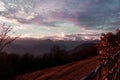 Snowed mountains, with colorful glowing clouds.