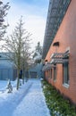 Snowed pathway along the brick wall of office building