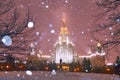 Snowfall in evenng winter campus of famous Russian university with snowed evergreen trees