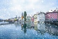 Snowfall in lucerne Reuss river with swiss buildings coverd in snow