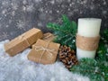 Snowfall over handmade candle and handcrafted Christmas gifts.