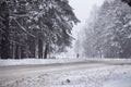 Snowfall and sleet on winter road. Ice snowy road. Winter snowstorm