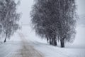 Snowfall and sleet on winter road. Ice snowy road. Winter snowstorm