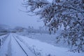 Snowfall and slippery road. Road safety in winter with snowfall. Winter cityscape. Small town street. Snow covered sidewalk. Urban