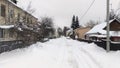 After the snowfall, there is snow on the streets of the city and it is on the roadway and sidewalks still not removed by the utili Royalty Free Stock Photo