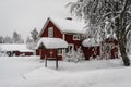 Snowfall in the village. Blurred background. Old wooden house in the snow. Traditional typical Scandinavian Swedish house or villa Royalty Free Stock Photo