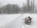 Snowfall in the winter park. A lonely bench in the park Royalty Free Stock Photo