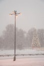 Snowfall in the winter. Snow blizzard in the city. Lantern, tree in the city, clearing the snow in the city Royalty Free Stock Photo