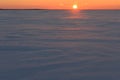 Snowfield in the rays of the setting sun, Russia