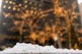 Snowflake with blurred christmas trees in the background.