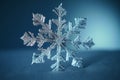 Snowflake closeup isolated on winter snow blue background. Copy space. Frozen water in crystal snowflake shape. Winter Christmas Royalty Free Stock Photo