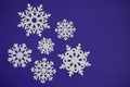 Snowflake cut outs on blue purple background