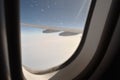 Snowflake on plane window frame height in sky