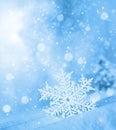 Snowflake shaped bokeh. Combined with blue background. Winter concept