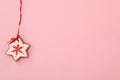 Snowflake shaped Christmas cookie on pink background, top view. Space for text