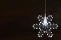 Snowflake shaped Christmas light on dark background