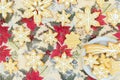 Snowflake-shaped sugar icing Christmas cookies, on a tablecloth with a Christmas pattern. Top view. Royalty Free Stock Photo
