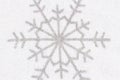 Snowflake on white textured fabric closeup background Royalty Free Stock Photo