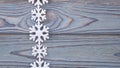Snowflakes border on grunge wooden background.