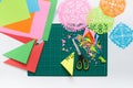 Snowflakes of colored paper. Scissors and cutting mat. Royalty Free Stock Photo