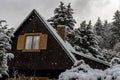 Snowflakes falling on a snowy roof of a cottage Royalty Free Stock Photo