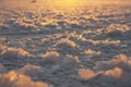 Snowflakes illuminated with champagne coloured light on the frozen surface of a lake