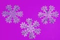 Snowflakes on a lilac background. Festive background. Holiday concept. Christmas and New Year concept. Top view, flat lay