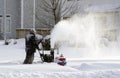 Snowing day worker blowing snow