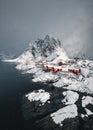 Snowing in Hamnoy fishing village with snowy mountain on coastline at Lofoten Islands