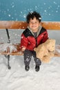 Snowing on a little boy