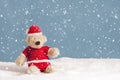 Snowing on teddy bear in christmas clothes Royalty Free Stock Photo
