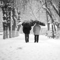 Snowing urban landscape with people