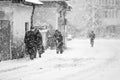 Snowing urban landscape with people