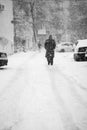 Snowing urban landscape with people