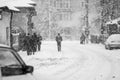 Snowing urban landscape with people